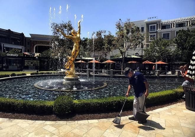 Golden statue and fountain in the plaza at The Americana at Brand in Glendale